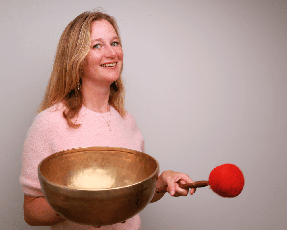 vrouw met grote klankschaal en klopper